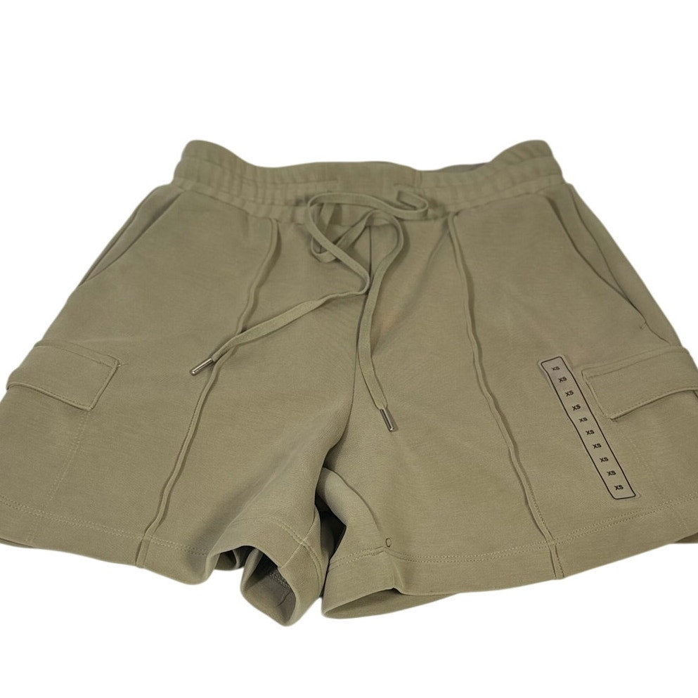 Calia women's sage green cargo shorts in size XS with drawstring waist, featuring utility pockets and a relaxed fit.