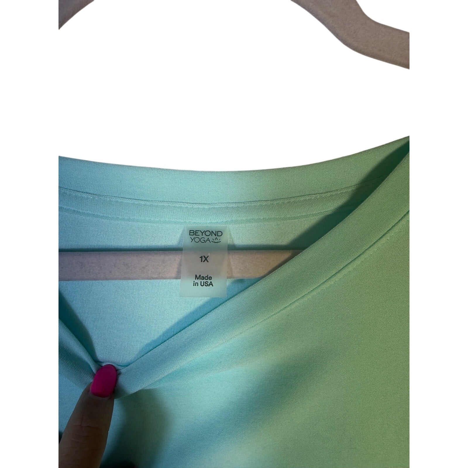 Beyond Yoga women's green sleeveless tank top, front view showing fitted design and soft fabric.