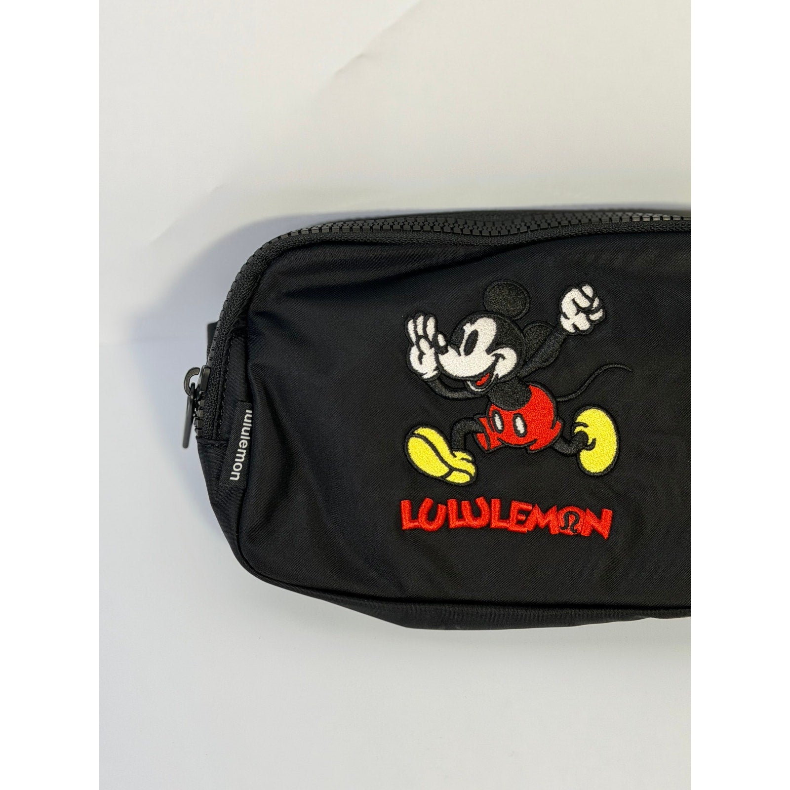 Lululemon Disney Mickey Mouse embroidered belt bag in black with adjustable strap, featuring playful Mickey Mouse embroidery.