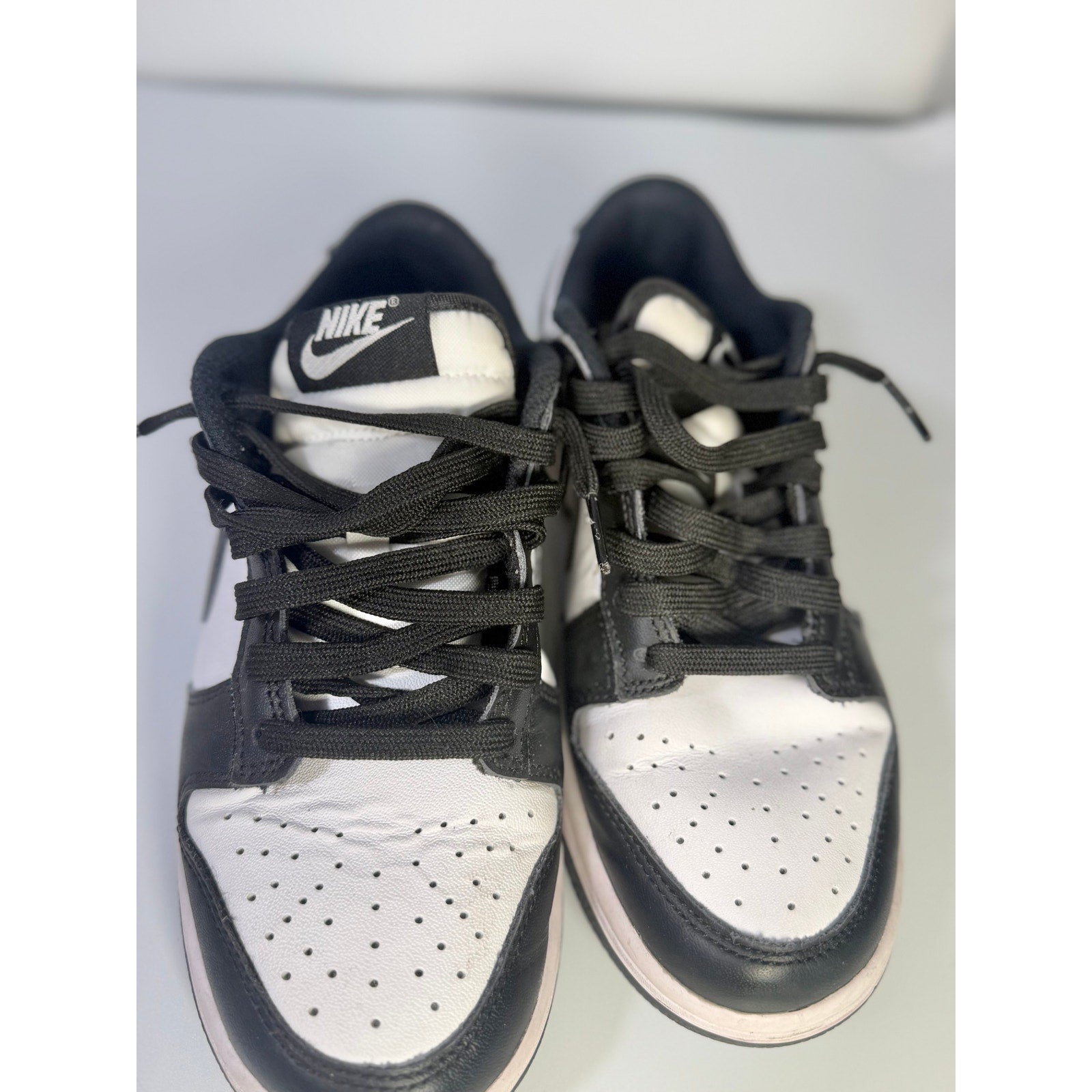 Nike Dunk Low Panda youth sneakers in black and white with a classic low-top design, size 5Y, featuring Nike branding.