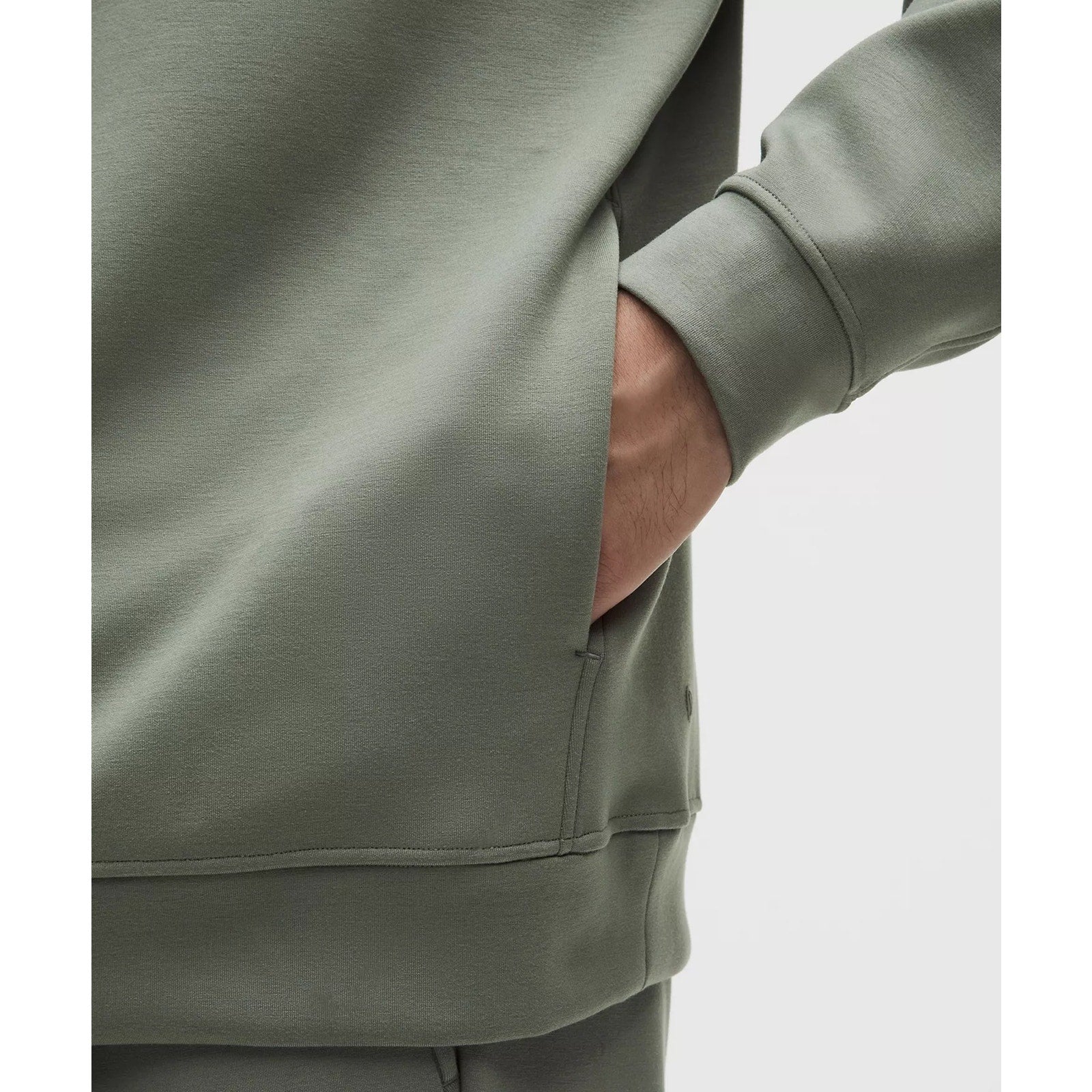 Men's green Lululemon Smooth Spacer Pullover Hoodie, medium size, showing the soft fabric and relaxed fit.