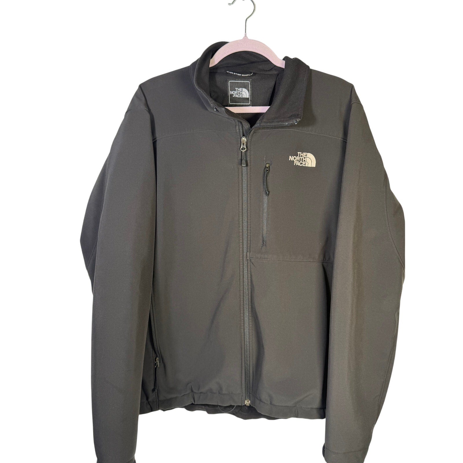 The North Face men's large black softshell jacket with full zip and fleece lining, designed for warmth and outdoor activities.