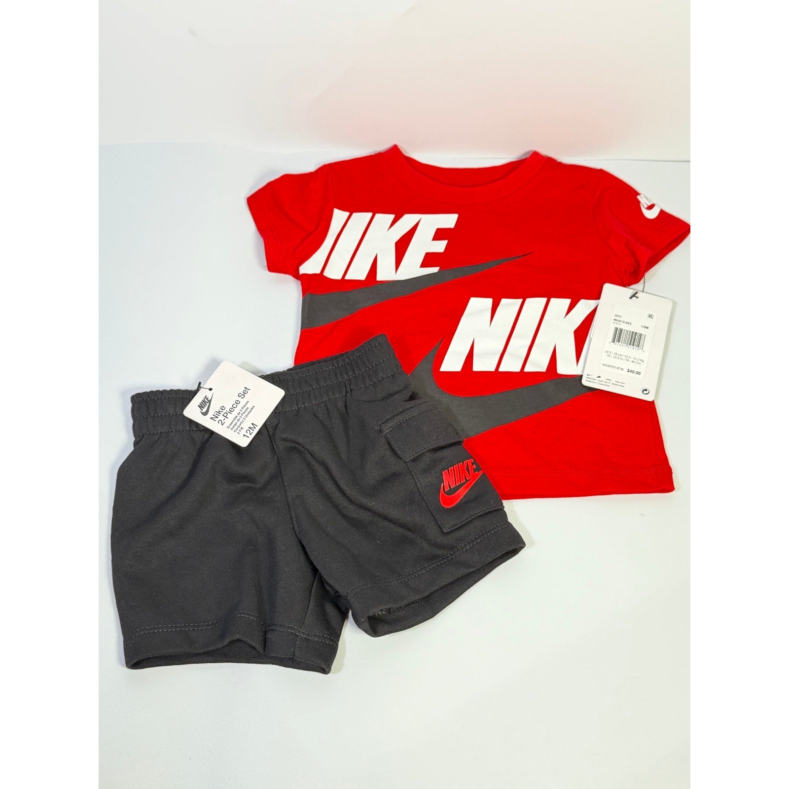 Nike baby boys 2-piece red and black t-shirt and shorts set for 12 months, featuring Nike branding and casual style.