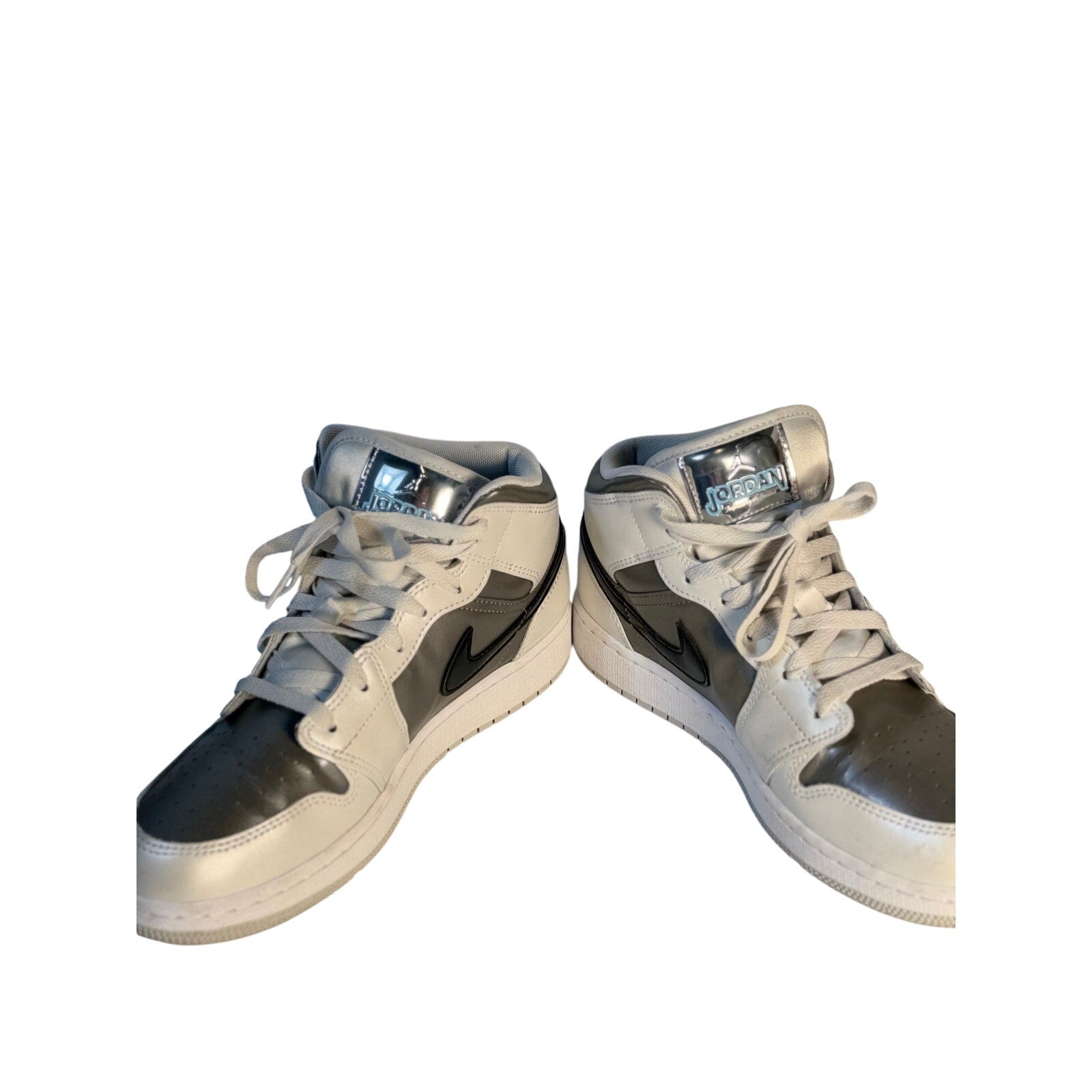 White, gray, and black Air Jordan 1 Mid GS sneakers for youth, size 7Y, featuring classic Jordan branding and design.