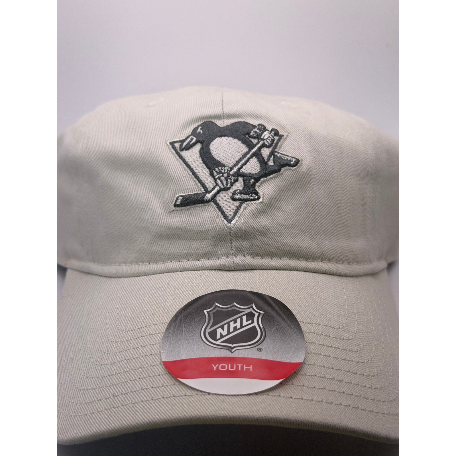 Beige NHL Pittsburgh Penguins youth adjustable strapback hat cap, one size, featuring team logo and classic design.