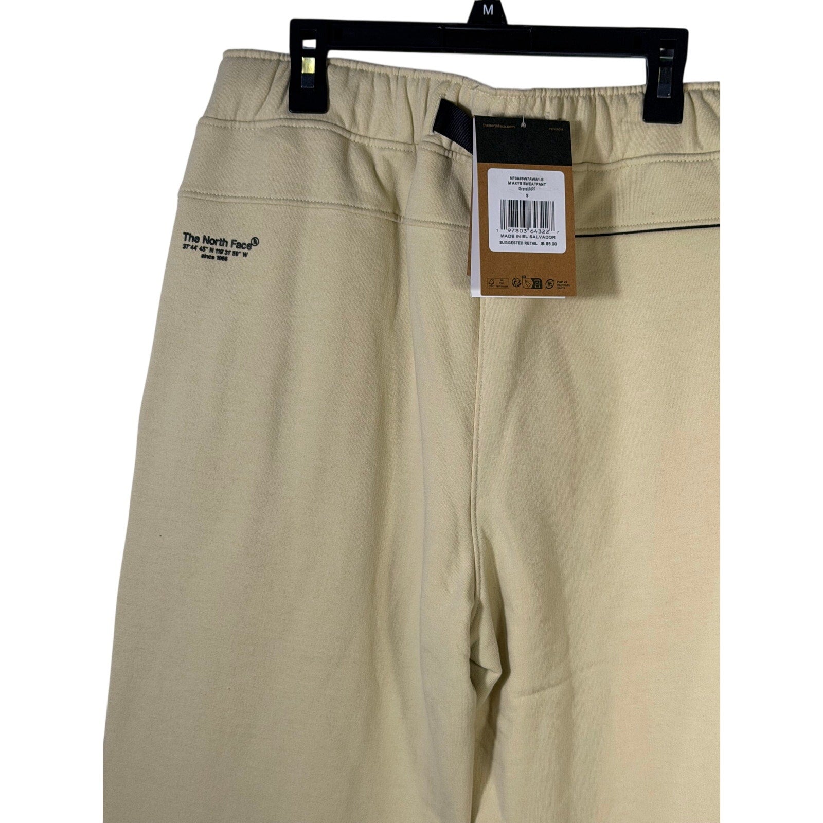 The North Face men's AXYS sweatpants in gravel beige, size S, showing the comfortable fit and logo detail.