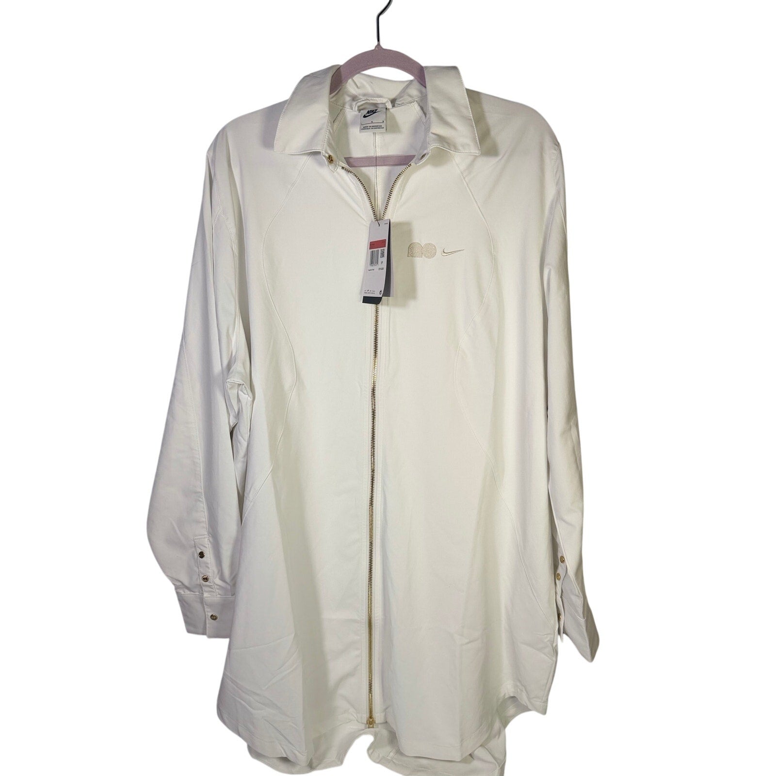 Nike women's long full zip jacket in cream, size XL, with Nike logo, shown front view with zip closure and hood.