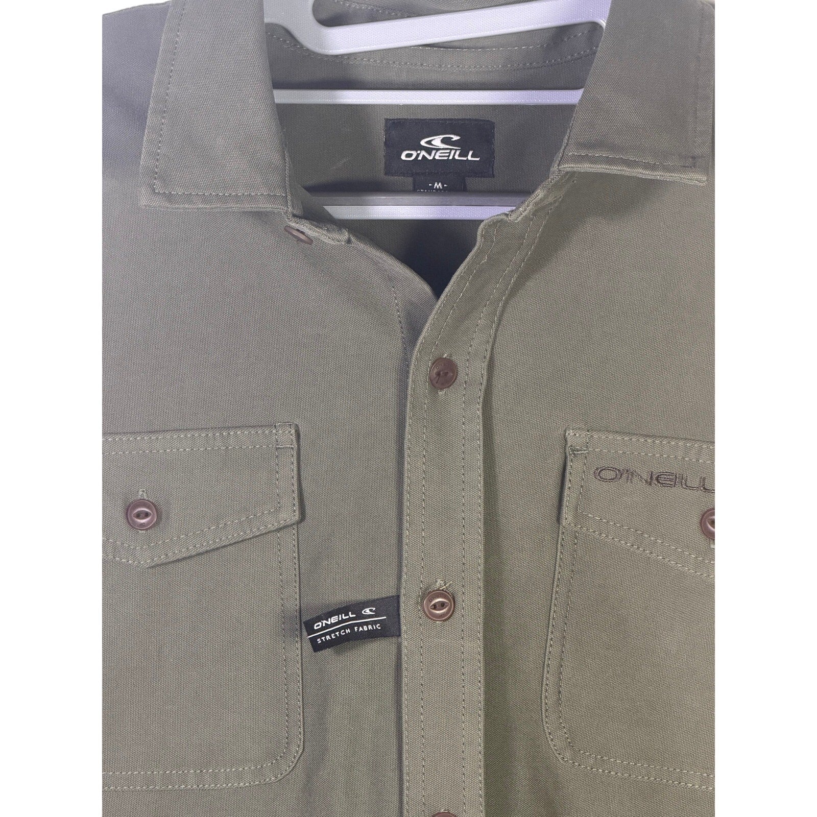 O’Neill men's olive green utility overshirt in size medium, shown flat with front view and button details.