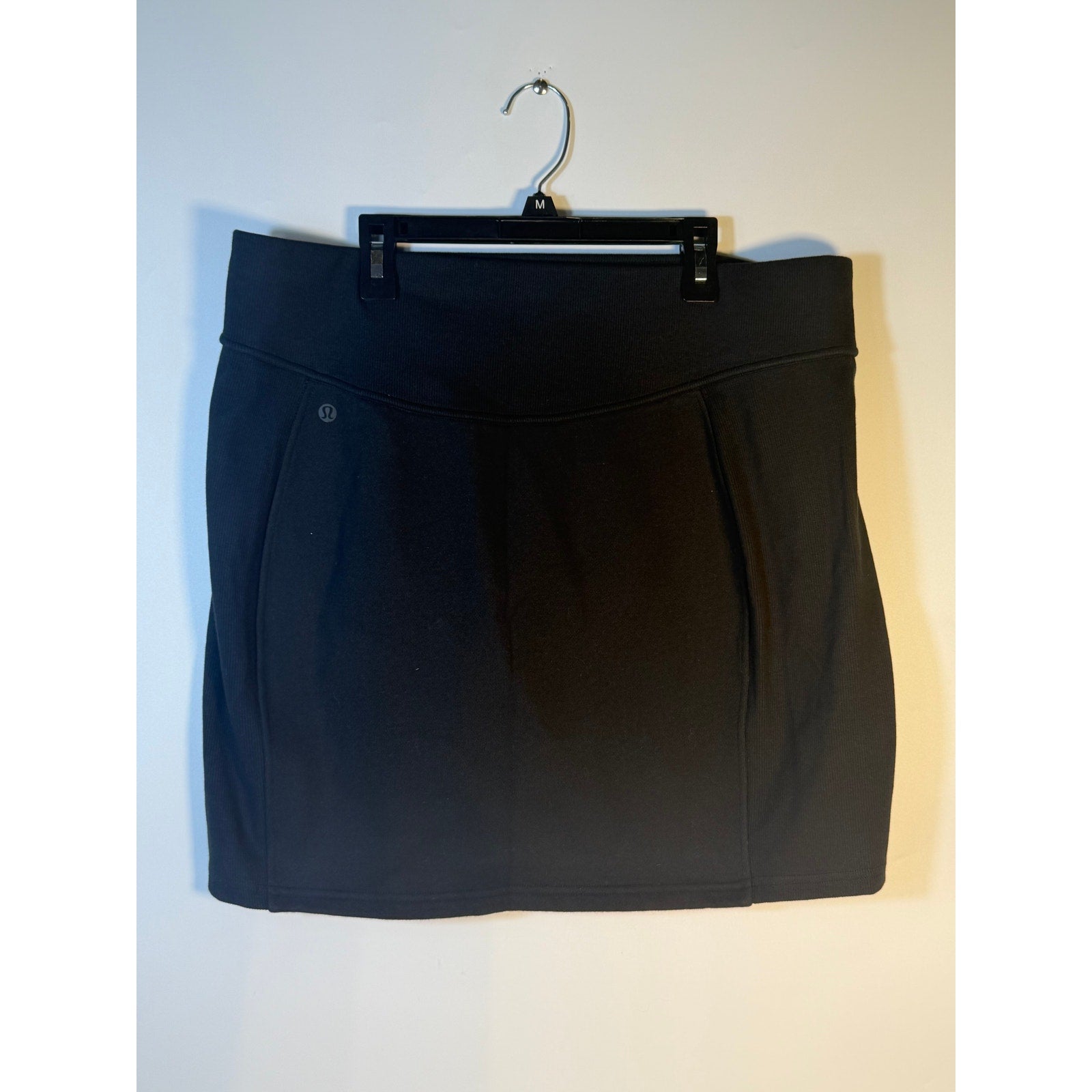 Black Lululemon Scuba HR Mini Skirt for women, XL size, made of fleece, above knee, suitable for athletic or casual wear.