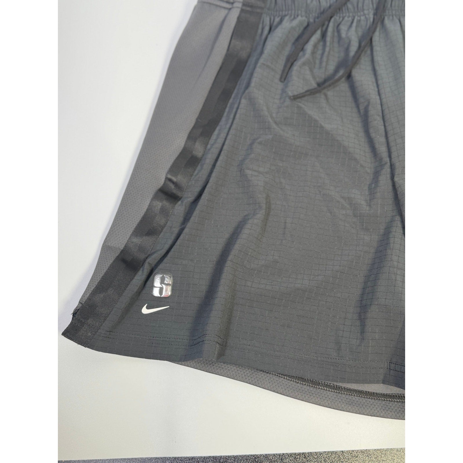Black Nike Crossover Women’s Dri-FIT 5" basketball shorts laid flat, showing lightweight athletic fabric and adjustable waist.