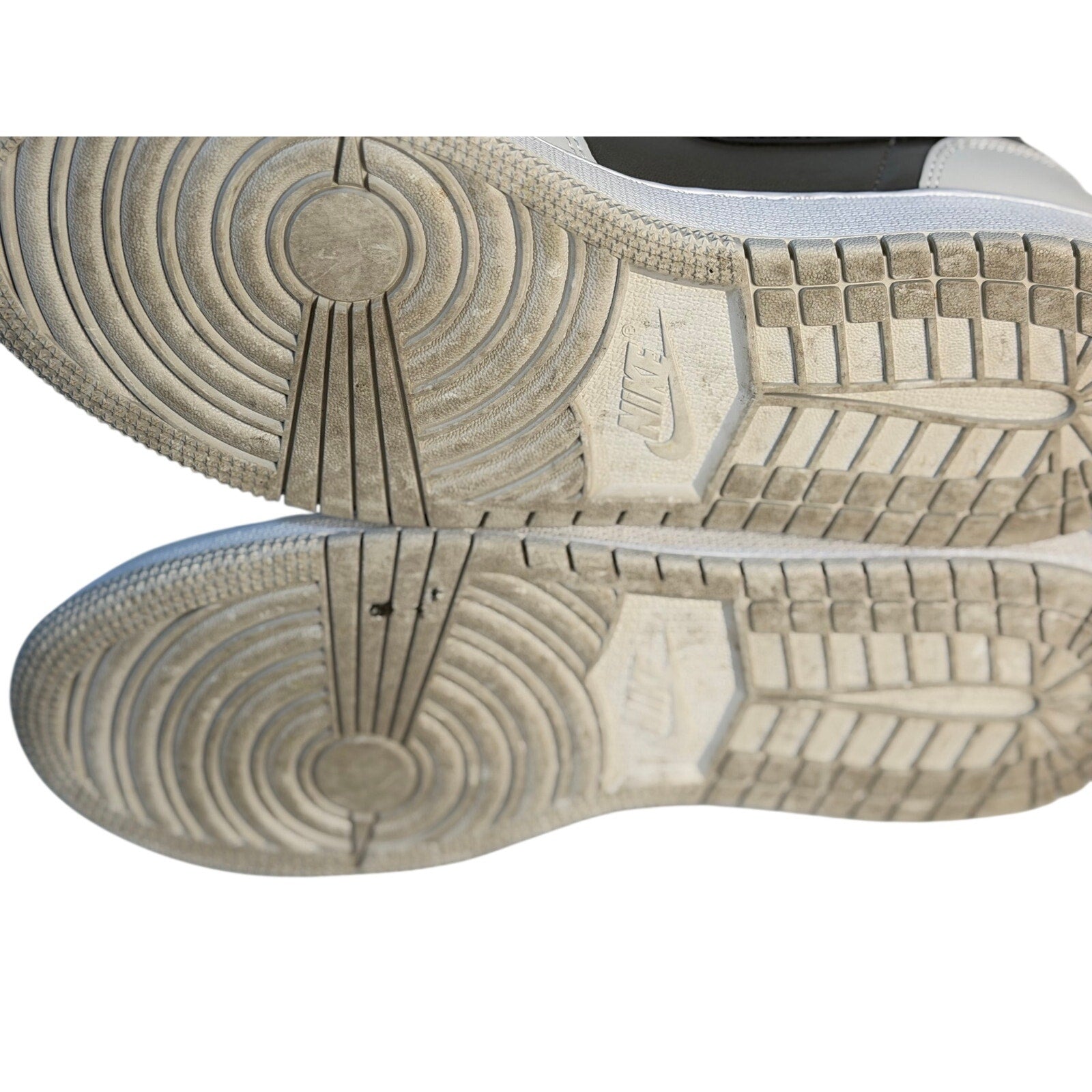 White, gray, and black Air Jordan 1 Mid GS sneakers for youth size 7Y, featuring classic Jordan design and high-top style.