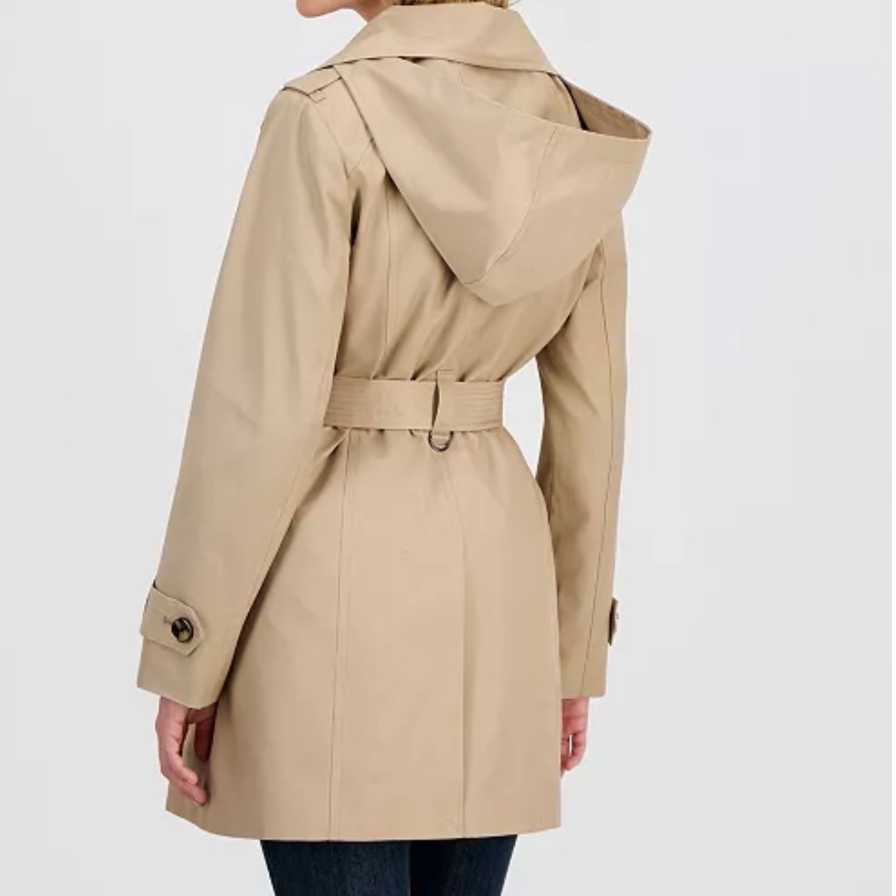 London Fog women's double lapel trench coat in size large, stylish classic design, new with tags, shown hanging on a clothing rack.
