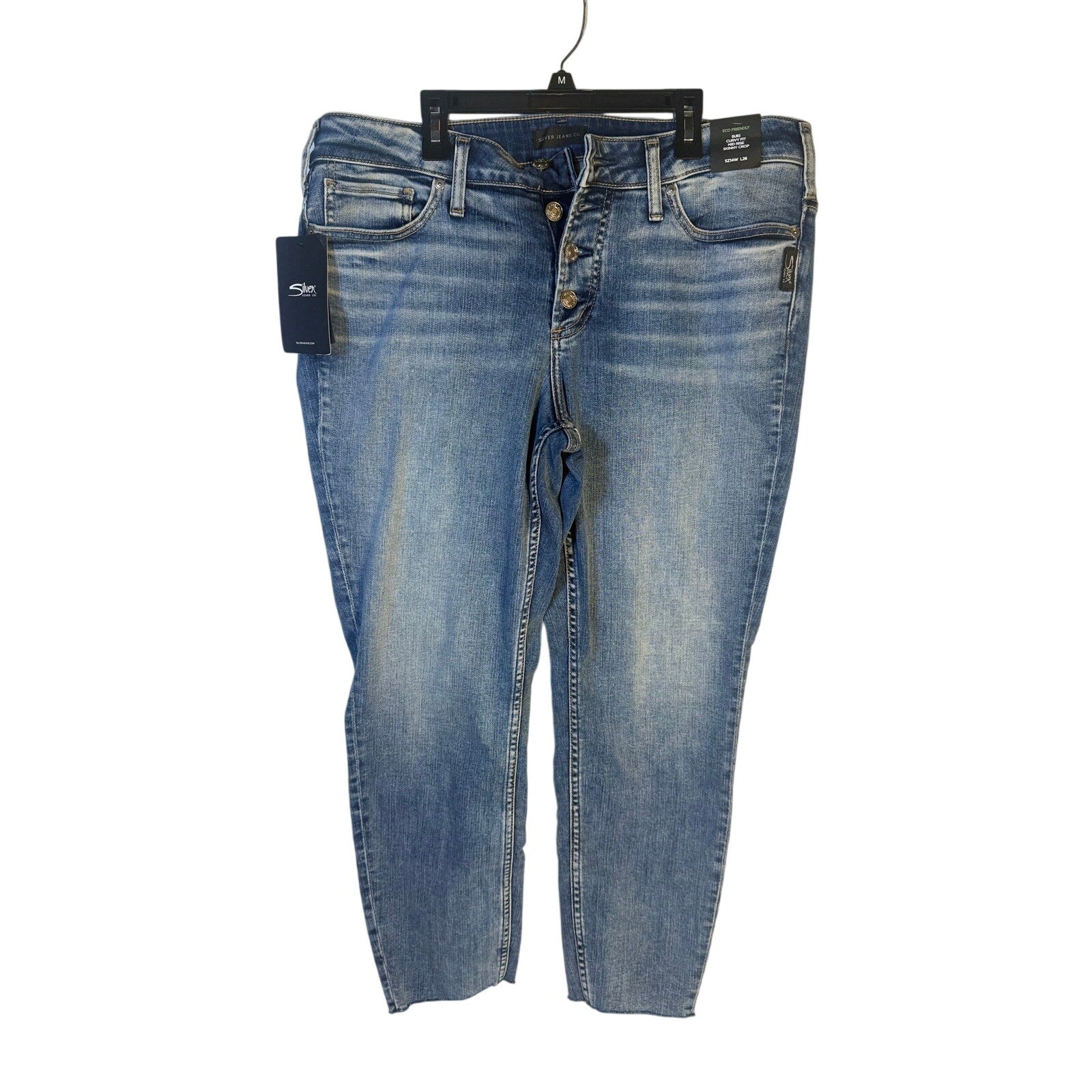 Silver Jeans Co. Suki curvy fit mid-rise skinny crop jeans for women, size 14W, displayed on a hanger.