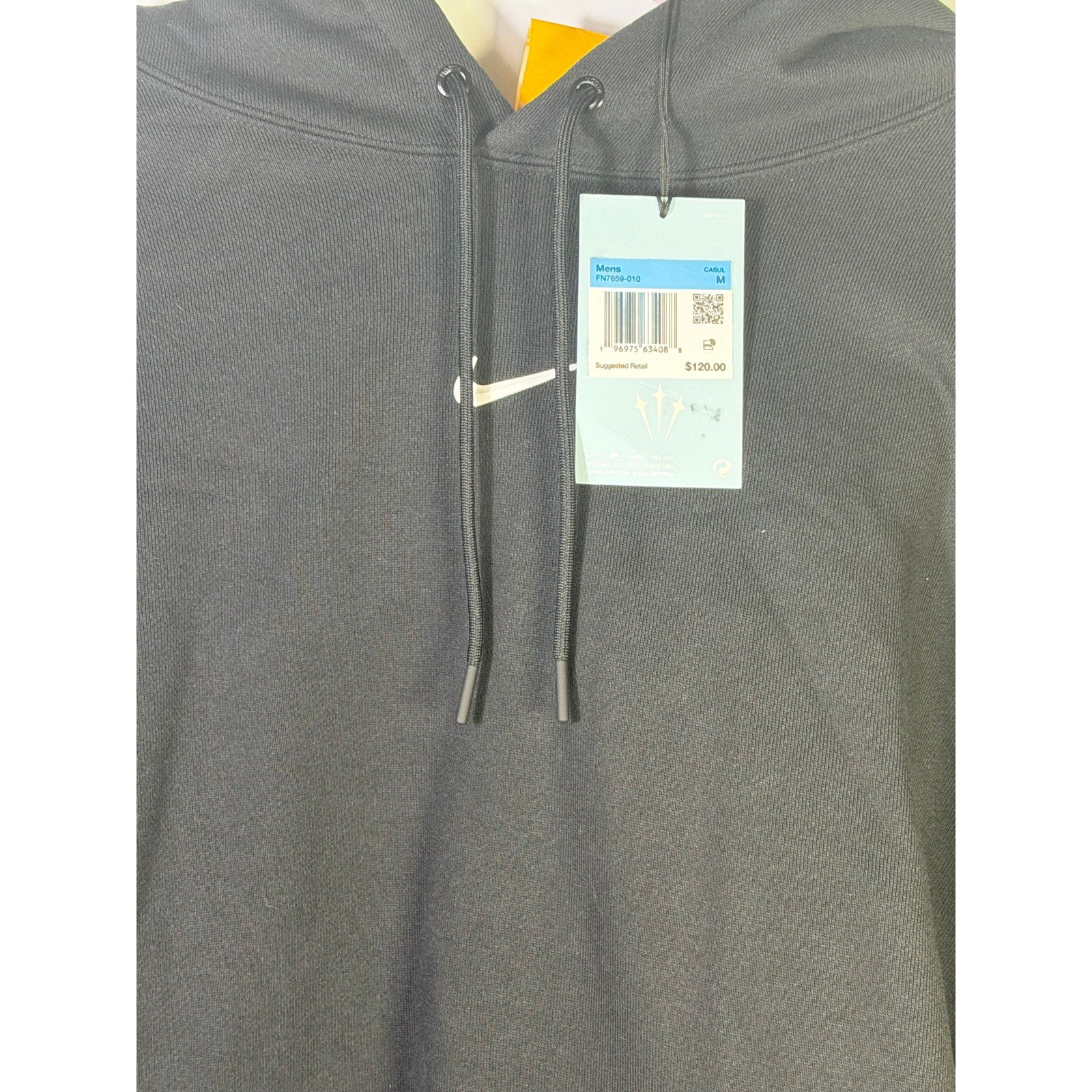 Nocta men's black fleece hoodie with tags, front view showing hoodie design and fabric texture. Size M.