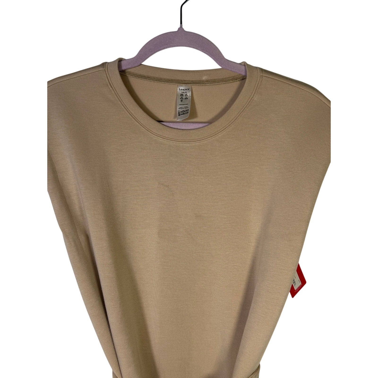 Spanx AirEssentials sleeveless tie-waist tank dress in Tahini, size large, laid flat showing front view with adjustable waist tie.