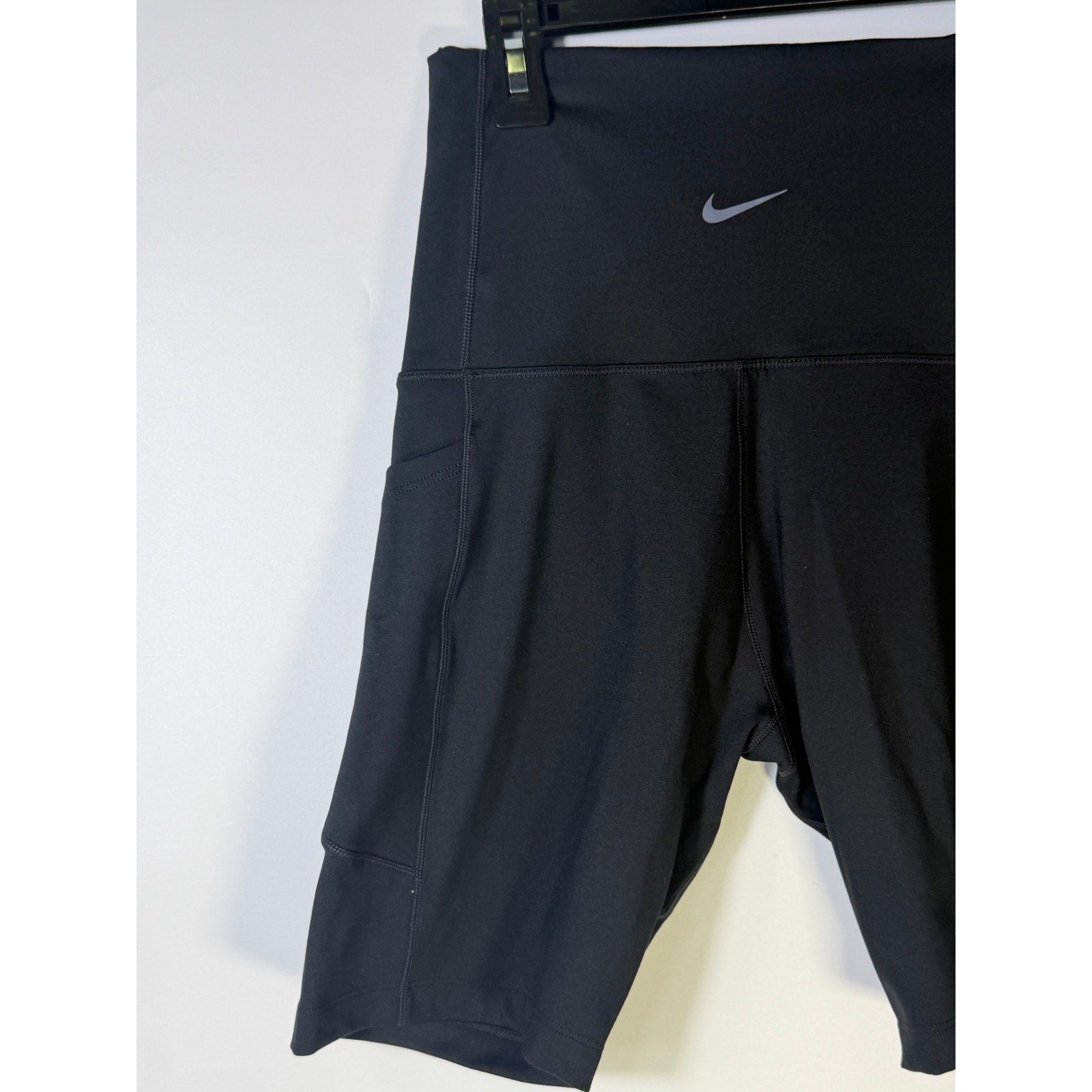 Nike women's black high-waisted training bike shorts, small size, shown flat with a sleek, stretchy fabric design.