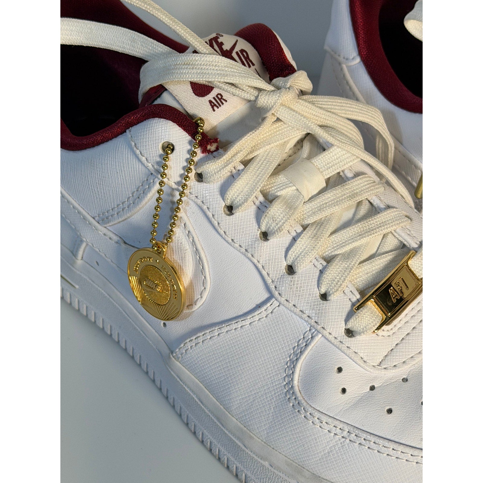 Nike Air Force 1 '07 LV8 men's sneakers in white with red accents, shown from the side in size 7.