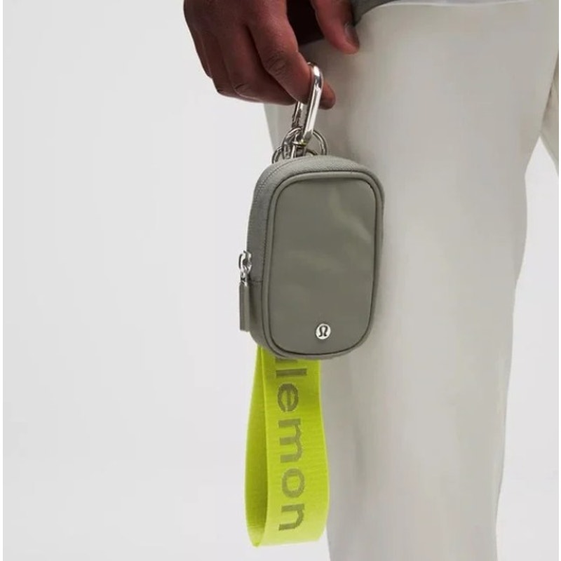 Lululemon Nano Pouch handbag in gray and green with a zipper closure, clippable mini bag with tags attached.