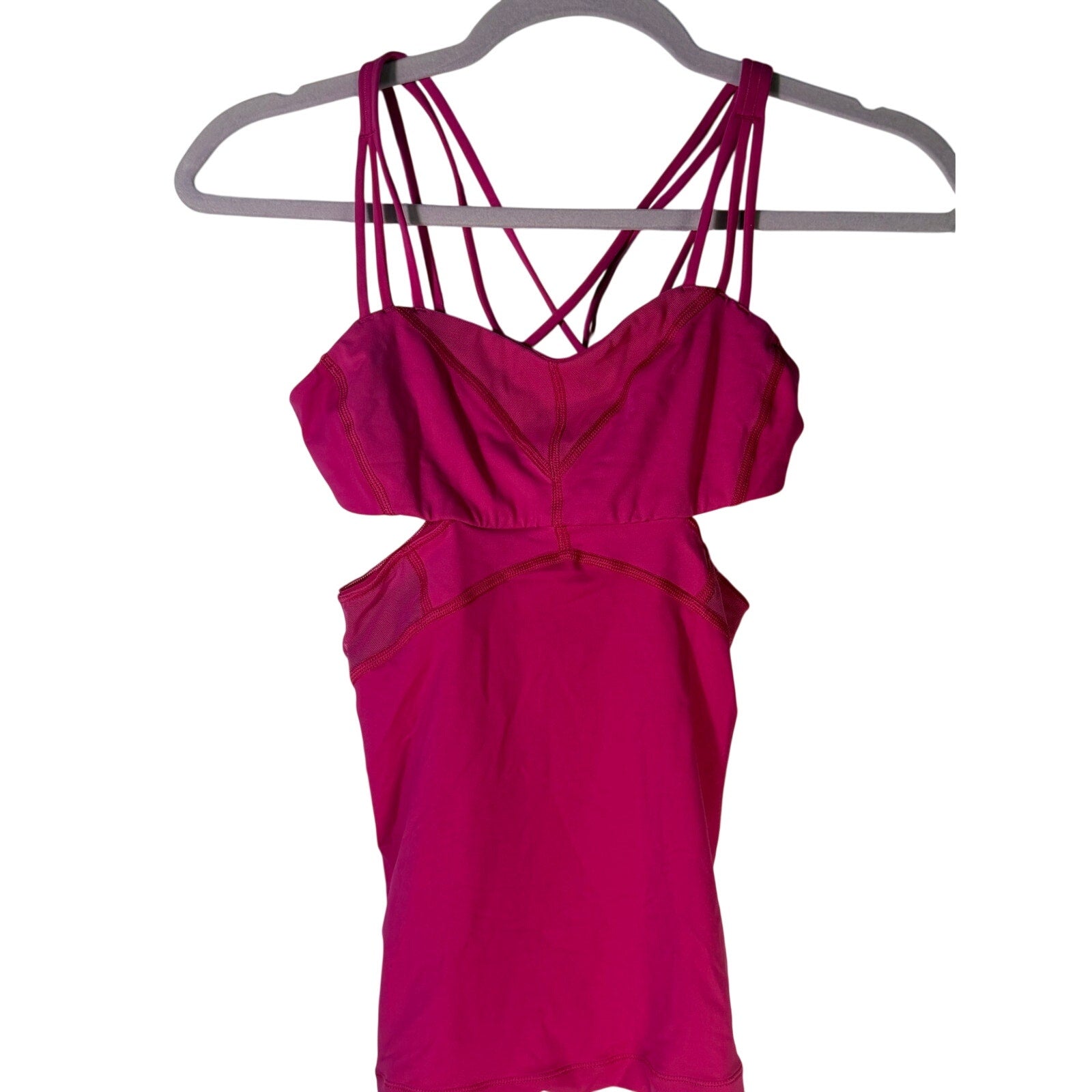 Lululemon women’s magenta strappy cutout athletic tank top, size 2, pre-owned, shown on a hanger with stylish design details.