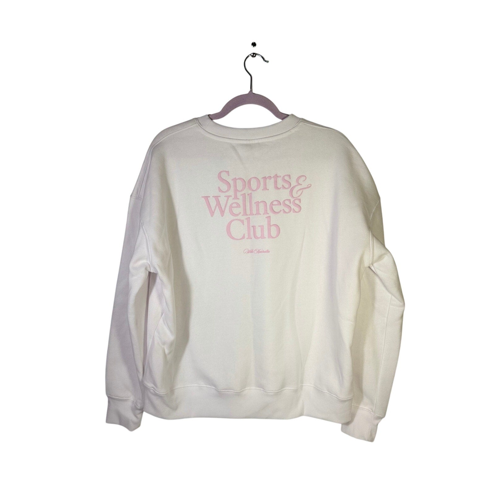 WILO The Label sports and wellness club crewneck sweatshirt in white and pink, medium size, displayed on a hanger