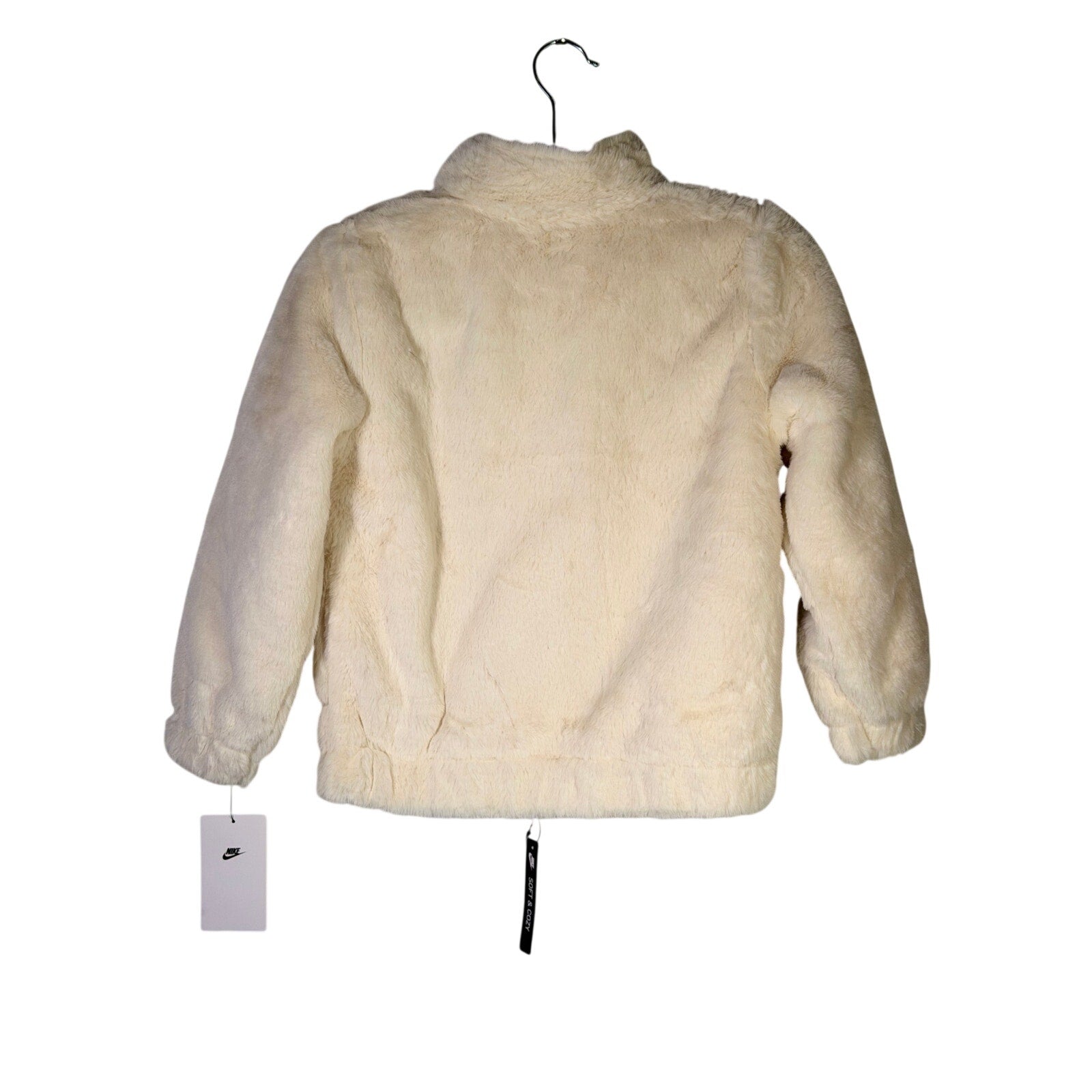 Nike girls' faux fur full zip jacket in cream and black, size 6X, oversized fit with Nike swoosh logo on the front.
