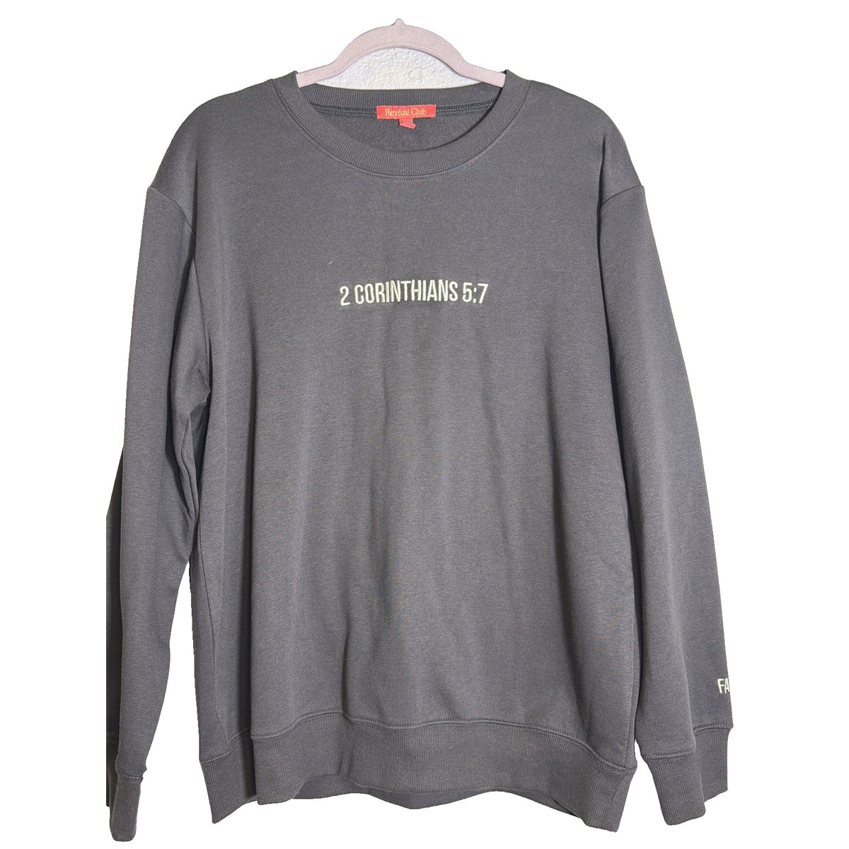 Women's charcoal Revival Club Walk By Faith Not By Sight crewneck sweatshirt, front view with logo and soft fabric texture.