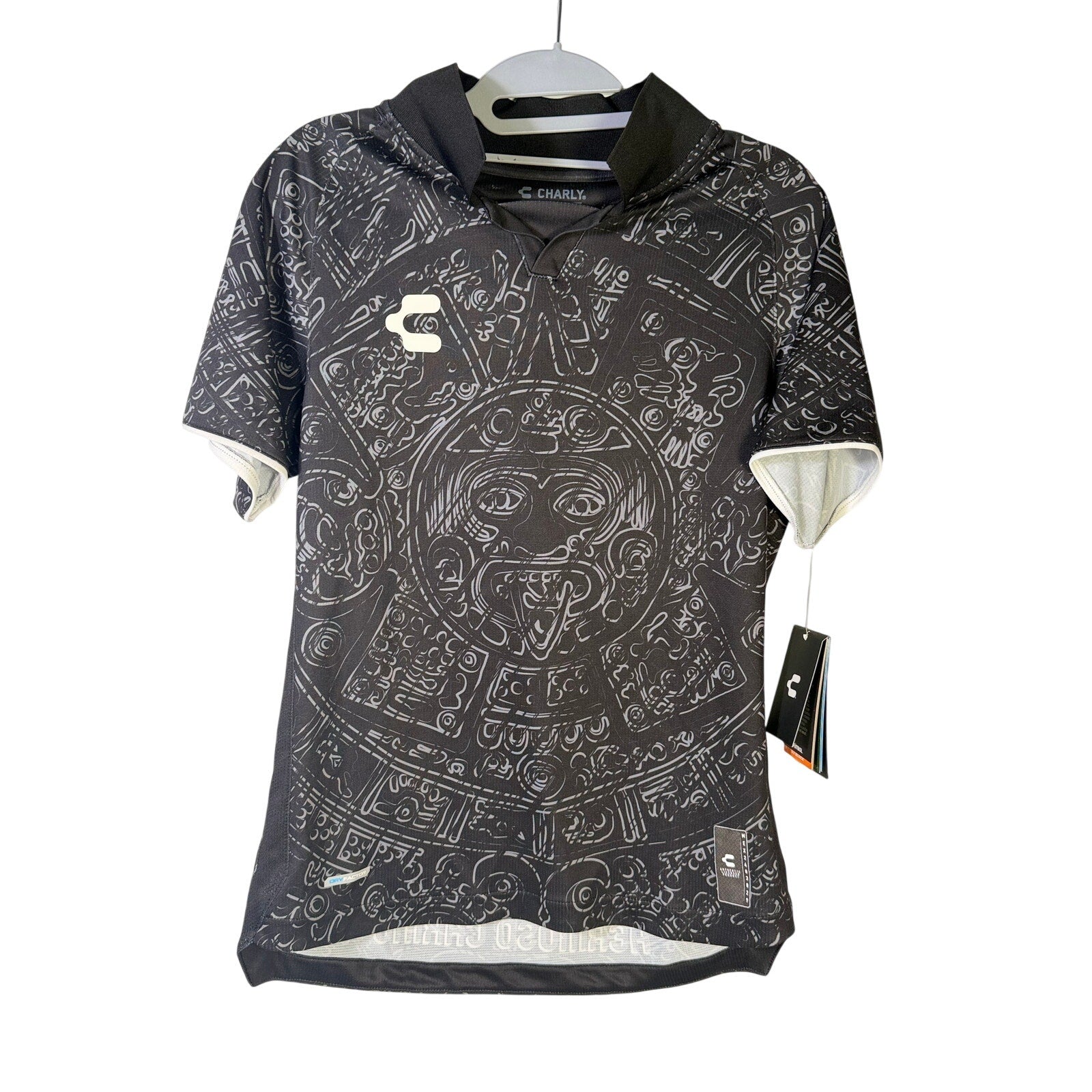 Men's black Charly Mexico Heritage SS soccer jersey with Aztec print, size XS, featuring short sleeves and athletic fit.