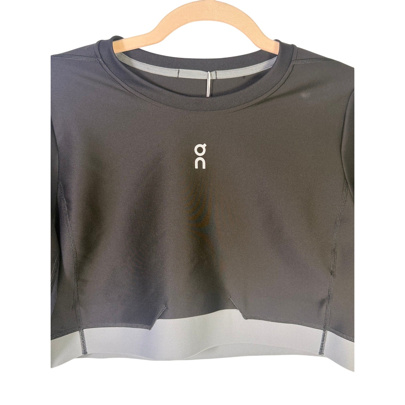 On women's black train long-sleeve crop athletic top in size XL, featuring a fitted design and logo on the front.