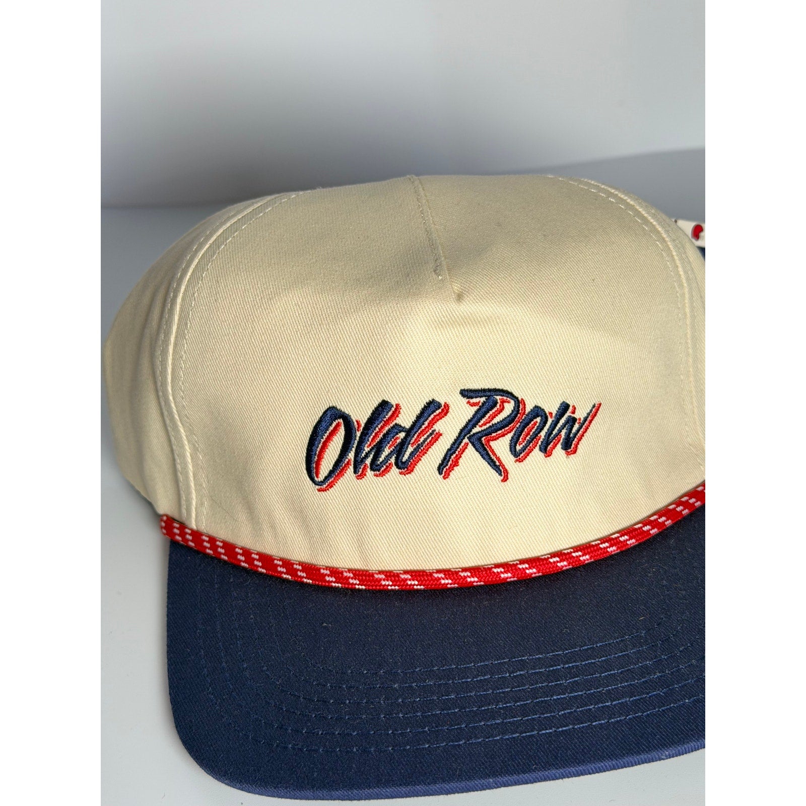 Old Row navy rope snapback hat with adjustable strap, featuring a classic design and branding, worn by an adult model.