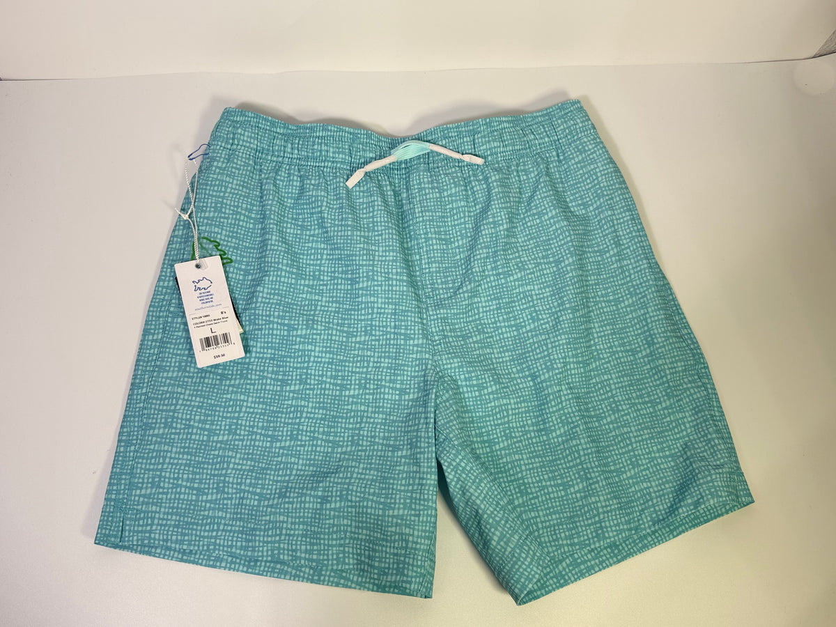 Southern Tide printed teal performance swim trunks for men, showing the colorful patterned fabric and elastic waistband.