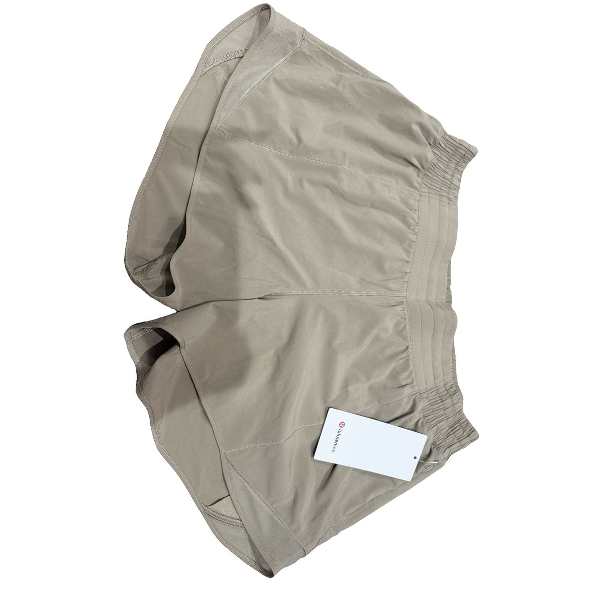 Lululemon Hotty Hot high-rise lined shorts in tan beige, women's size 14, showing the front view and lightweight fabric.