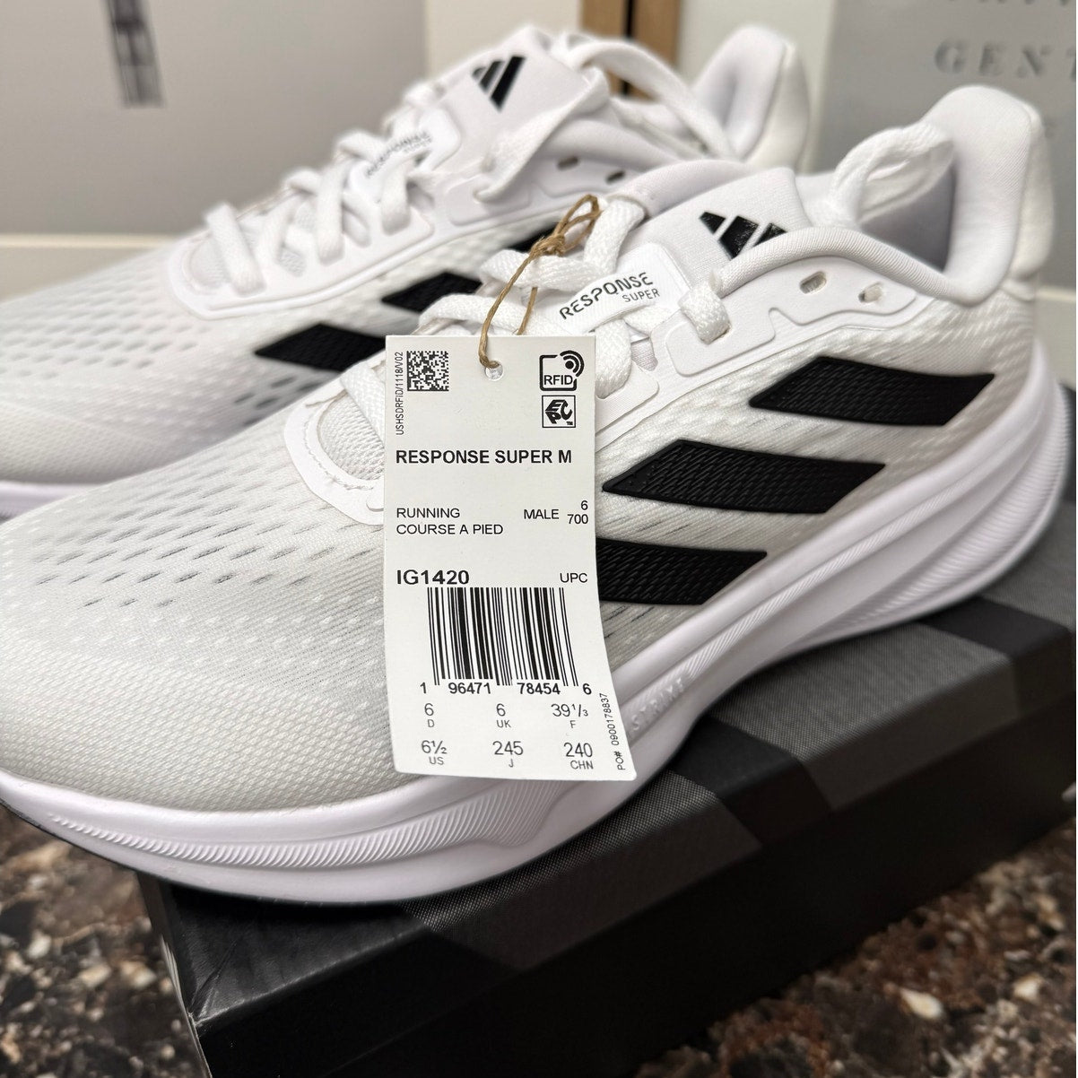 Adidas Response Super women's running sneakers in white, black, and silver with breathable mesh and cushioned soles.