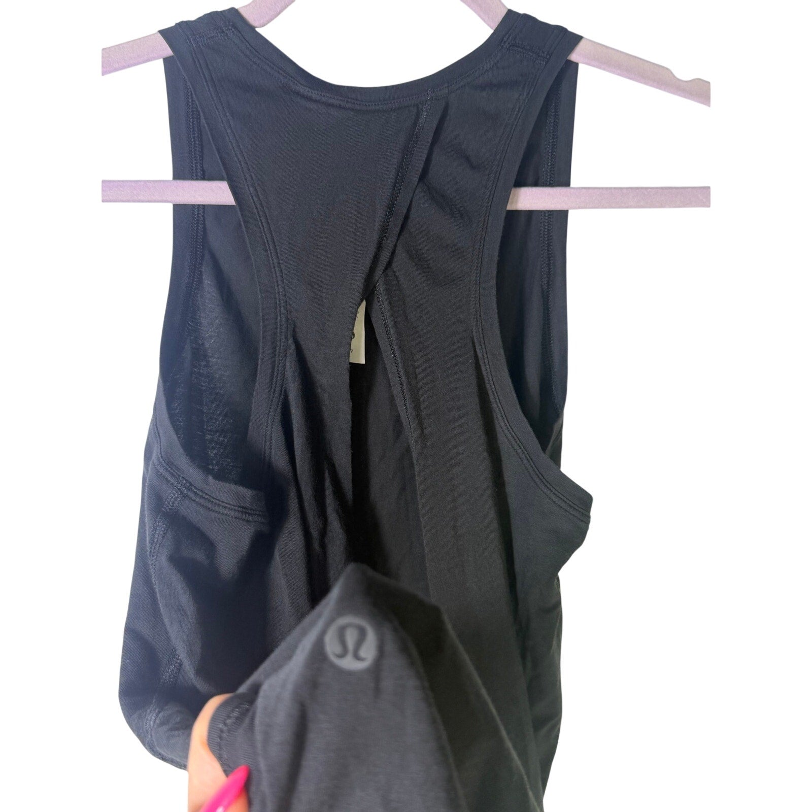 Lululemon women's black high-neck open-back athletic tank top, size 4, made of lightweight, breathable fabric, displayed on a white background.