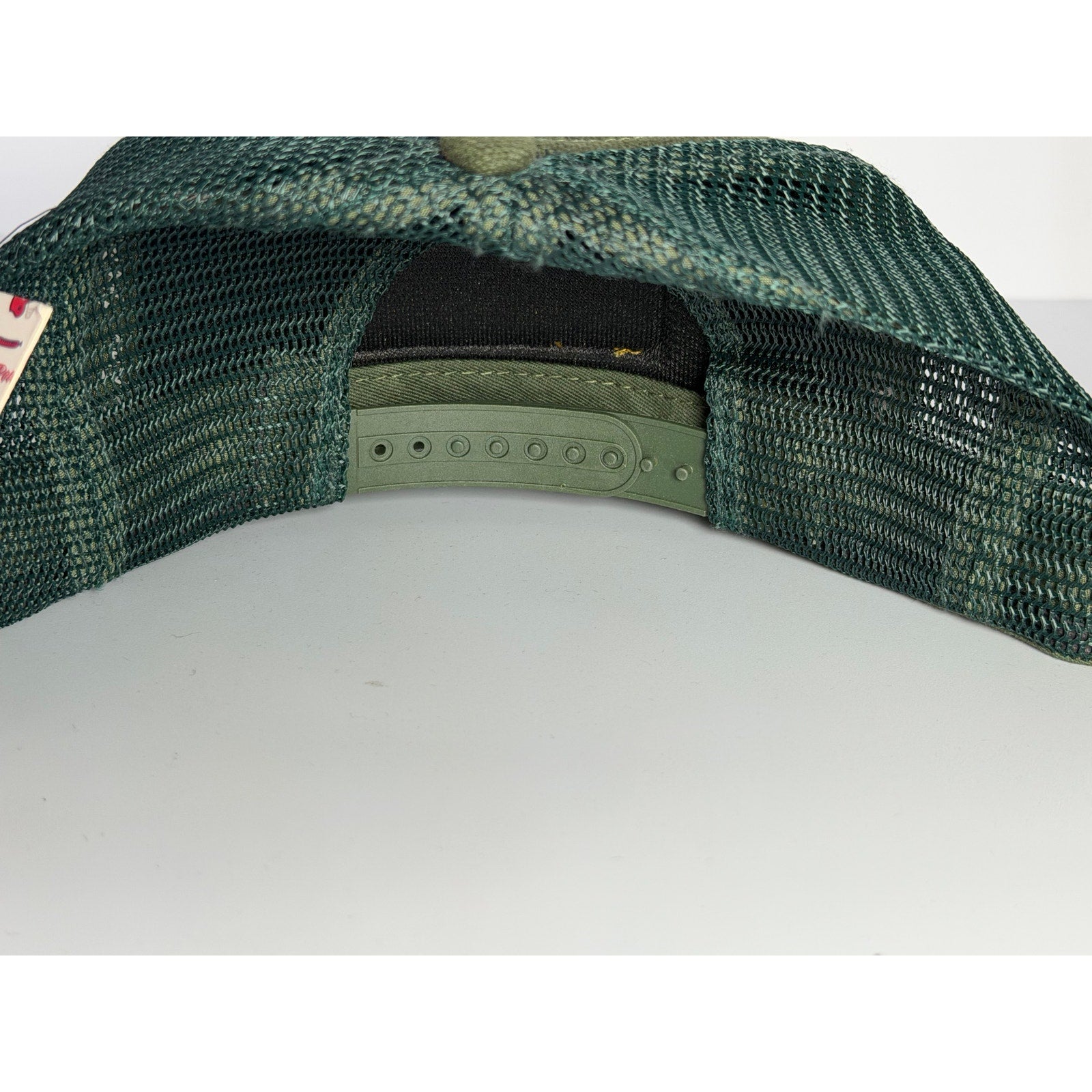 Old Row olive green rope trucker hat with adjustable snapback strap, featuring a casual cap style and classic branding.