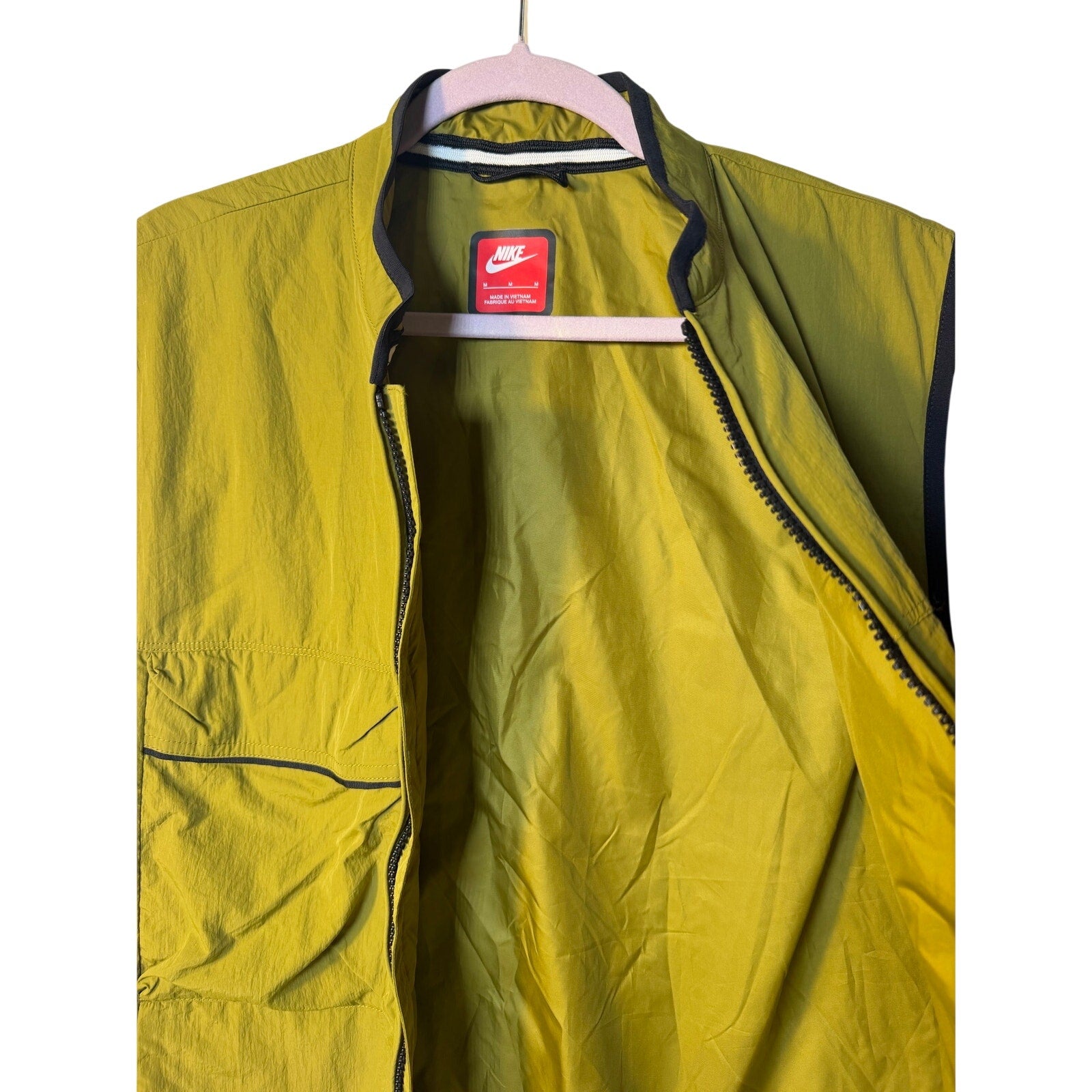 Green Nike Tech Woven Utility Wind Vest for men, full zip, size medium, designed for lightweight wind protection.