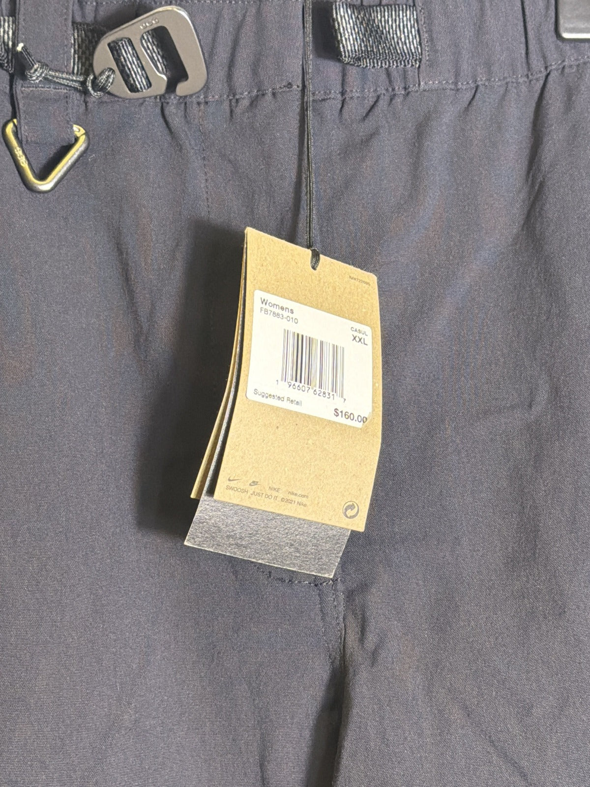 Nike ACG women's convertible zip-off cargo hiking pants in black, size XXL, featuring multiple pockets and adjustable zip-off legs.