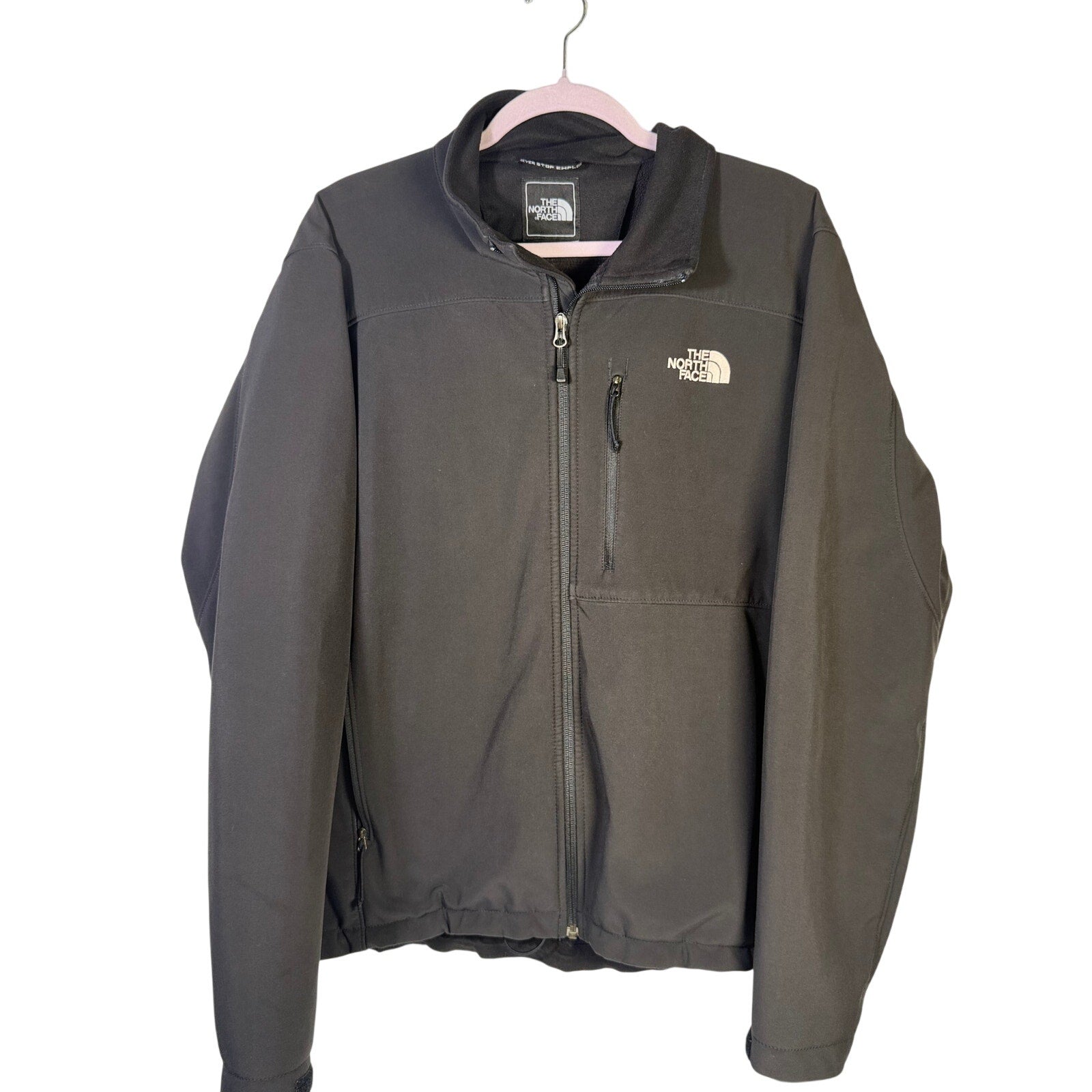 Black The North Face men's softshell jacket with fleece lining, full-zip design, suitable for cold weather.