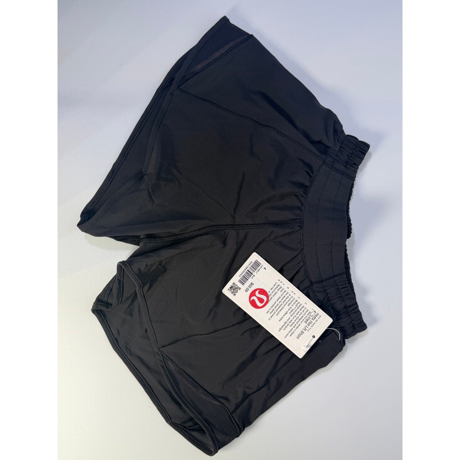 Lululemon Hotty Hot low rise lined shorts in black, women's size 4, 4-inch inseam, with a comfortable fit and athletic style.