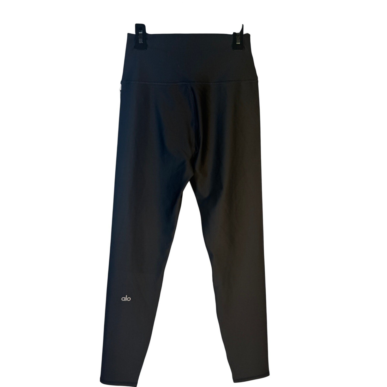 Black Alo Yoga Airlift 7/8 high waist leggings for women, shown laid flat with waistband and fabric details.