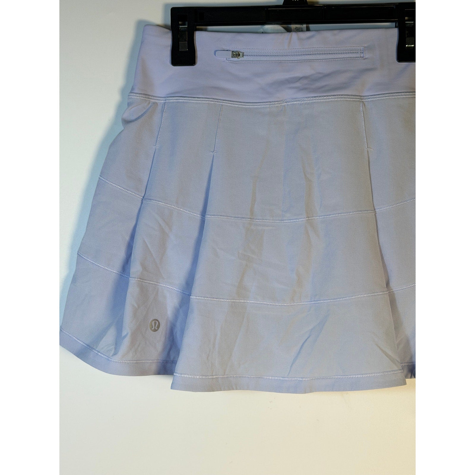 Light blue Lululemon women's tennis skort in size 2, athletic activewear skirt with built-in shorts and a sleek, sporty design.
