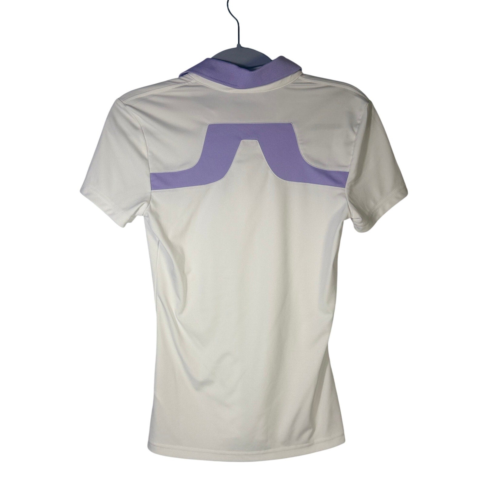 White and lavender J.Lindeberg women’s golf polo shirt in size XS, short sleeve, with a classic fit and subtle branding.