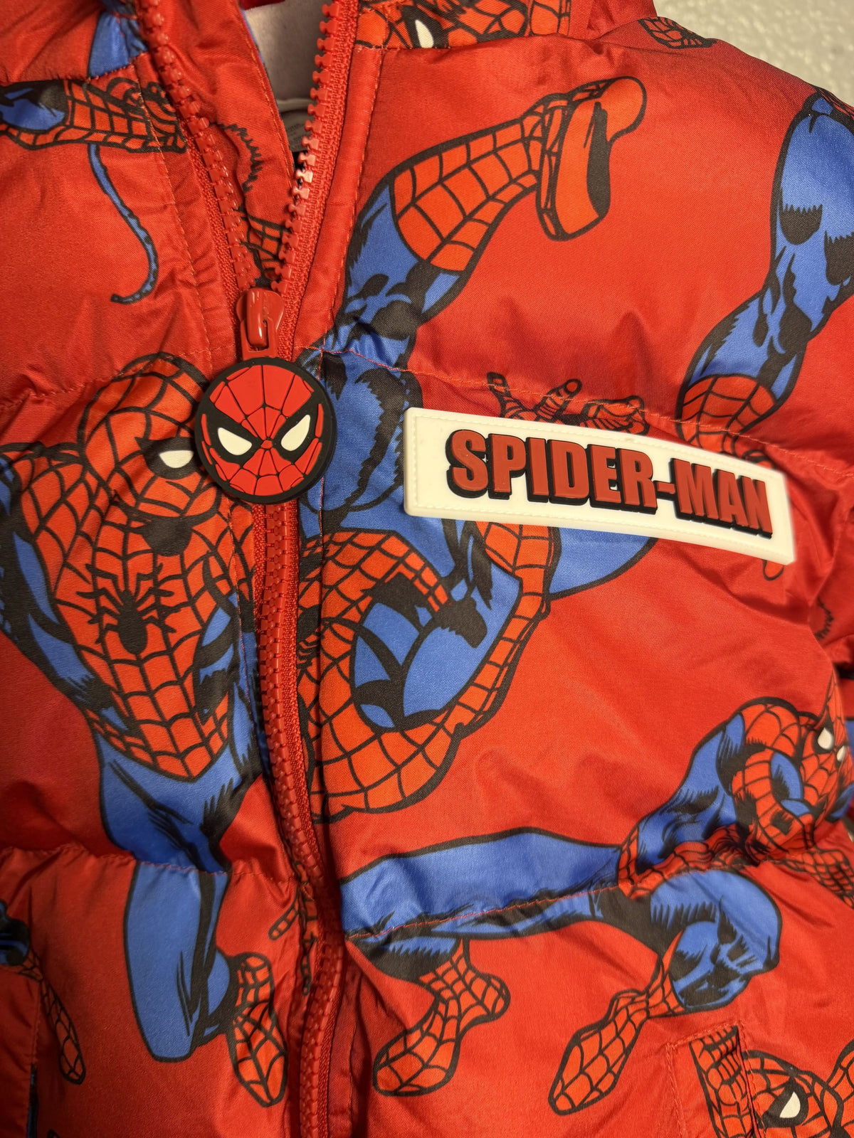 Marvel Spider-Man hooded puffer jacket for boys in red with sherpa lining, featuring Spider-Man graphics and a cozy, insulated design.