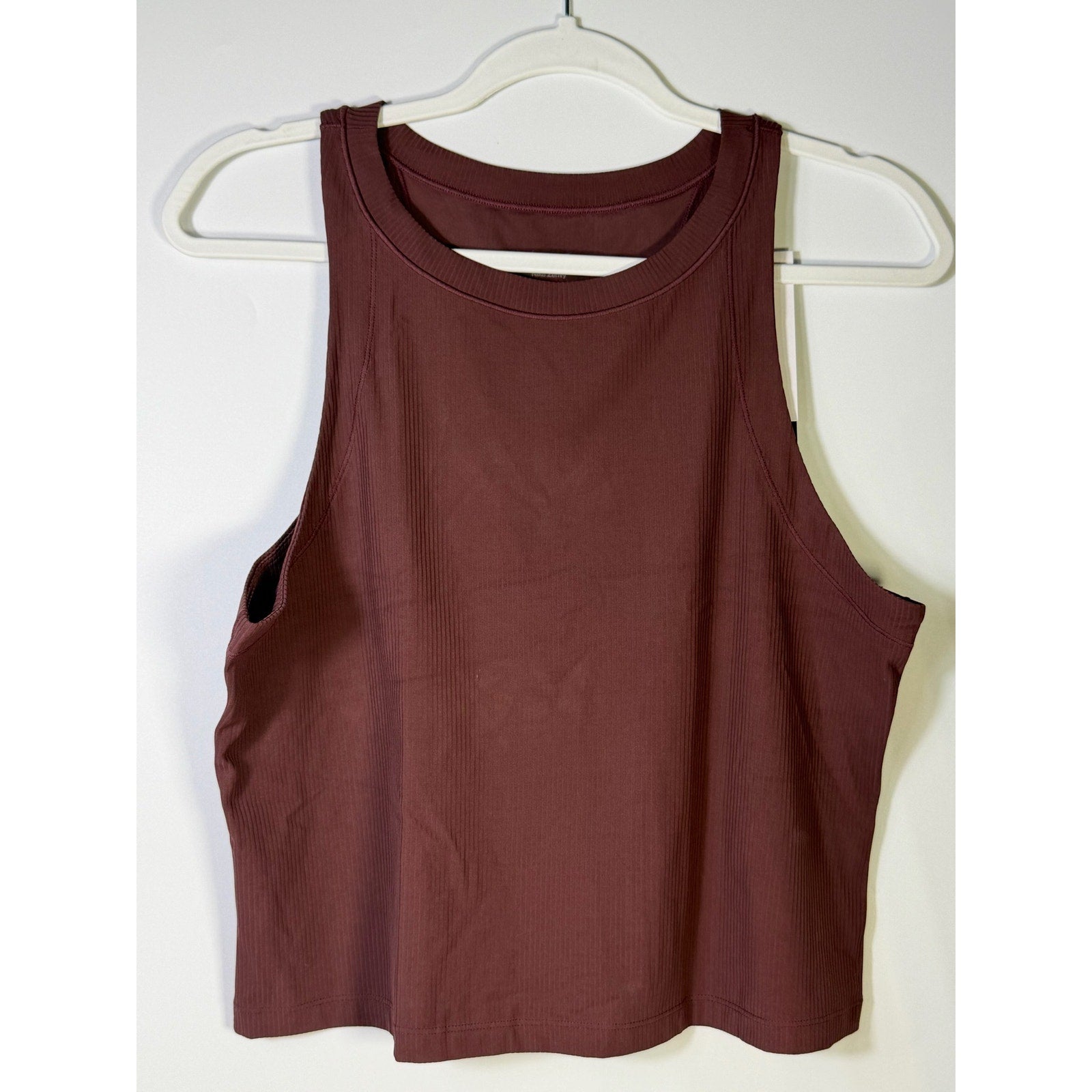 Nike women's ribbed cropped muscle tank top in brown, size large, displayed flat with visible ribbed texture.