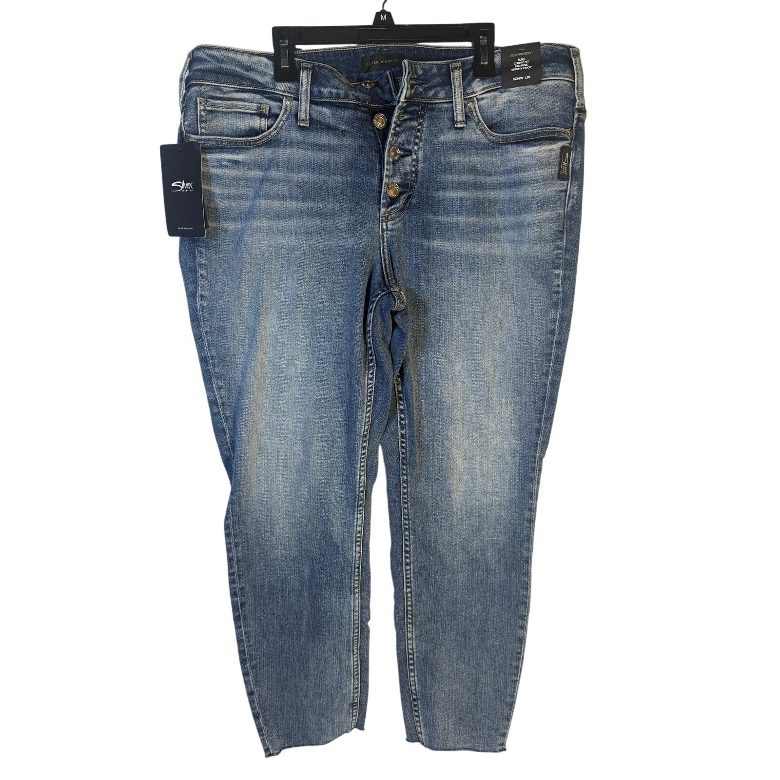 Silver Jeans Co. Suki curvy fit mid-rise skinny crop jeans for women, size 14W, shown on a model with a light wash finish.