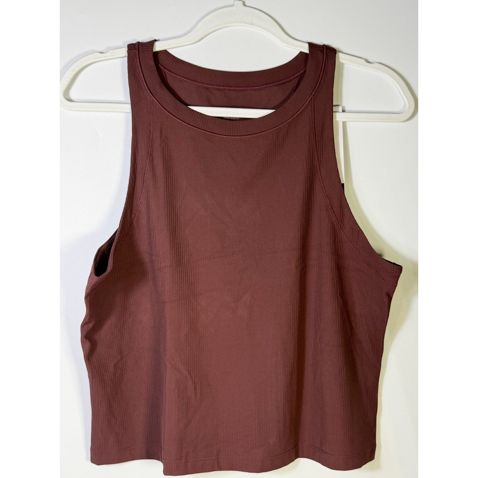Nike women's brown ribbed cropped muscle tank top, size L, featuring a fitted sleeveless design with Nike branding.