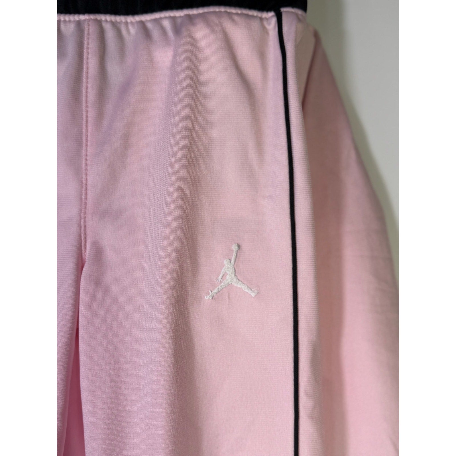 Jordan toddler girls pink and black 2-piece track jacket and pants set, size 2T, with Nike branding and sporty design.