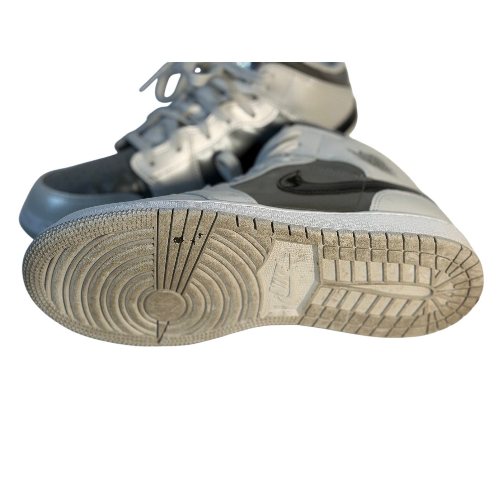 Jordan Air Jordan 1 Mid GS sneakers in white, gray, and black for youth size 7Y, featuring classic design and sporty style.