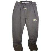 Fear of God Essentials 1977 Sweatpants in iron color, size XXL, showing relaxed fit and soft fabric details.