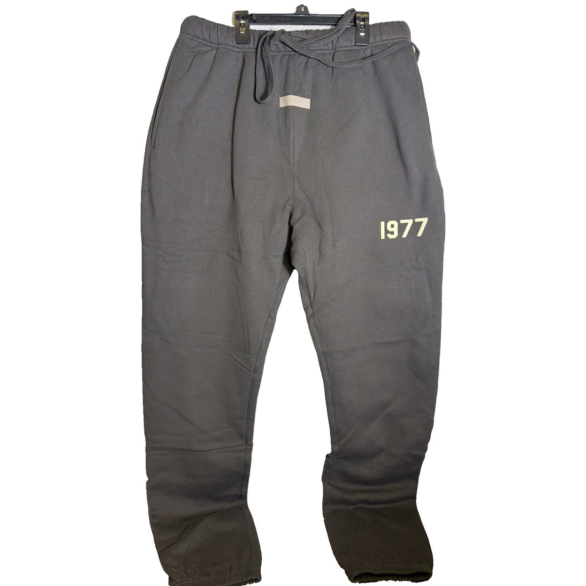 Fear of God Essentials 1977 Sweatpants in iron color, size XXL, showing relaxed fit and soft fabric details.