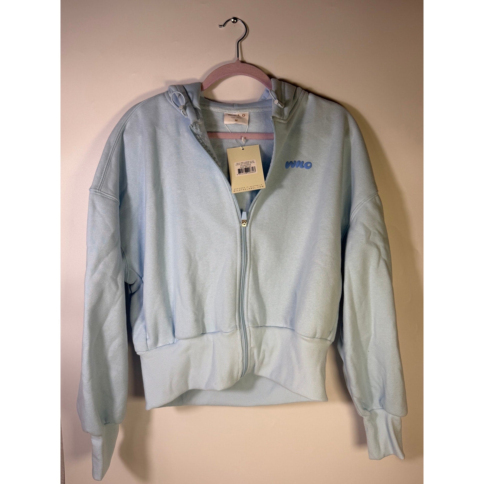 Blue Wilo The Label Wellness Club crop zip hoodie for women, size M, featuring a hood and front zipper.